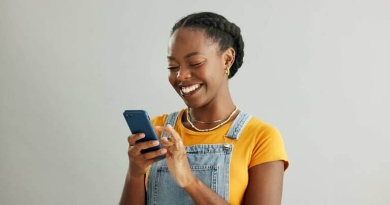 African woman, phone and texting in studio with smile, How to Call a Blocked Number