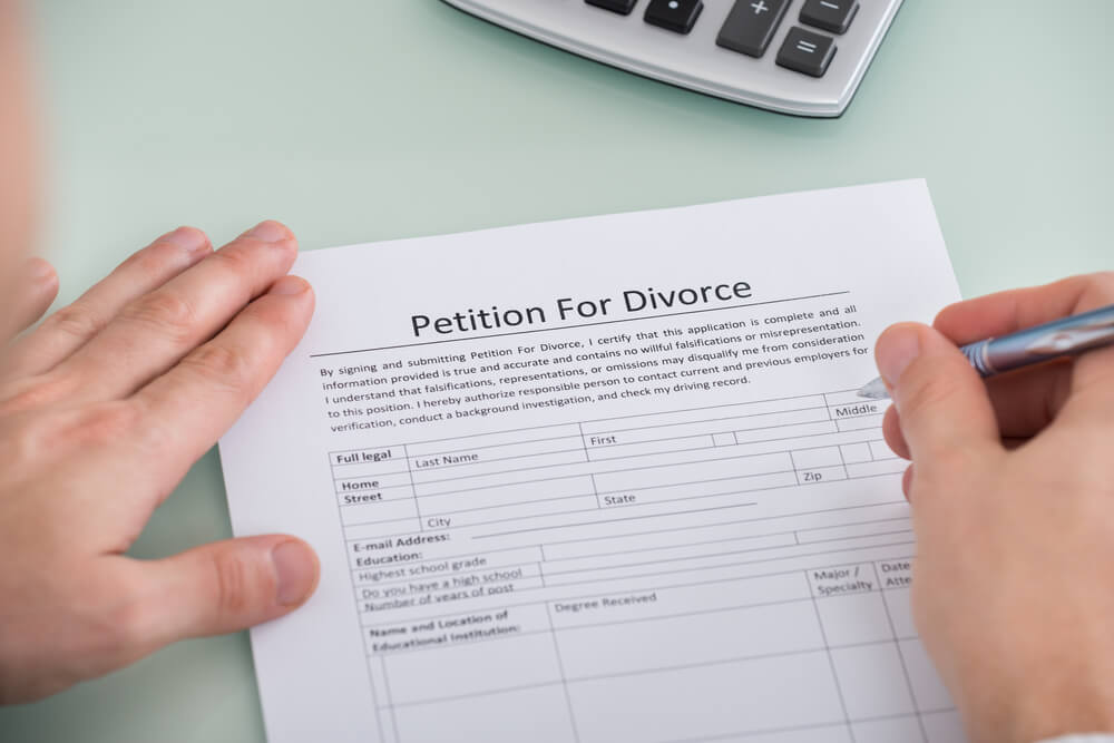 A person filling out paperwork related to divorce records in Tennessee.